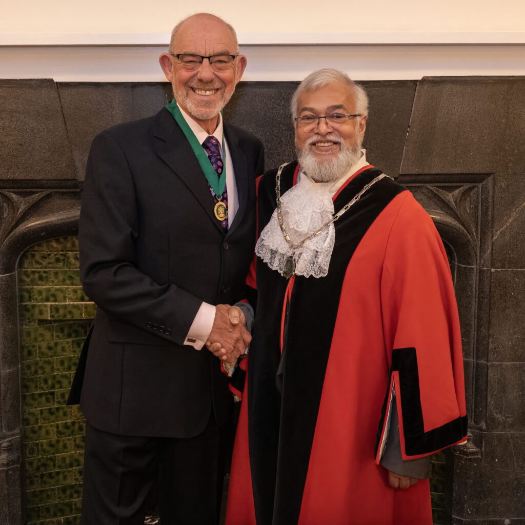 Councillors Aziz Chowdhry and Alan Monaghan Photograph of Councillor Alan Monaghan and Councillor Aziz Chowdhry shaking hands in front of the fireplace at Poole Court, Yate